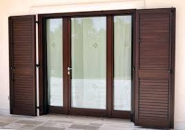 A wooden bifold door with brown shutters and a glass door.