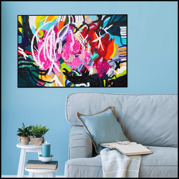 An abstract canvas print hangs above a couch in a living room.