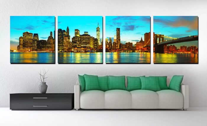 The Brooklyn Bridge at night as a canvas print in a living room.