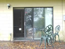 A patio with bifold doors in front of a house.