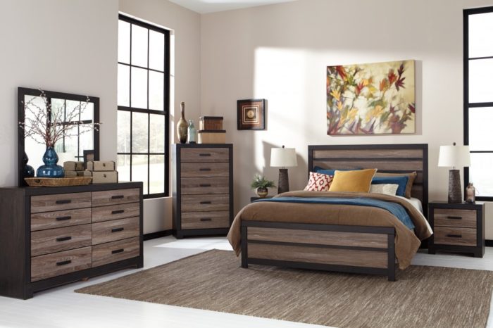 A bedroom set designed for a good night's sleep, including a bed, dresser, and mirror.