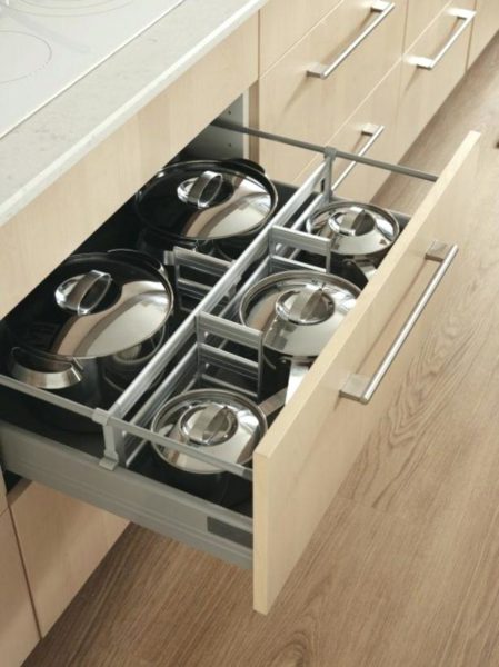A kitchen with a drawer full of pots and pans is part of the top kitchen trends of 2019.