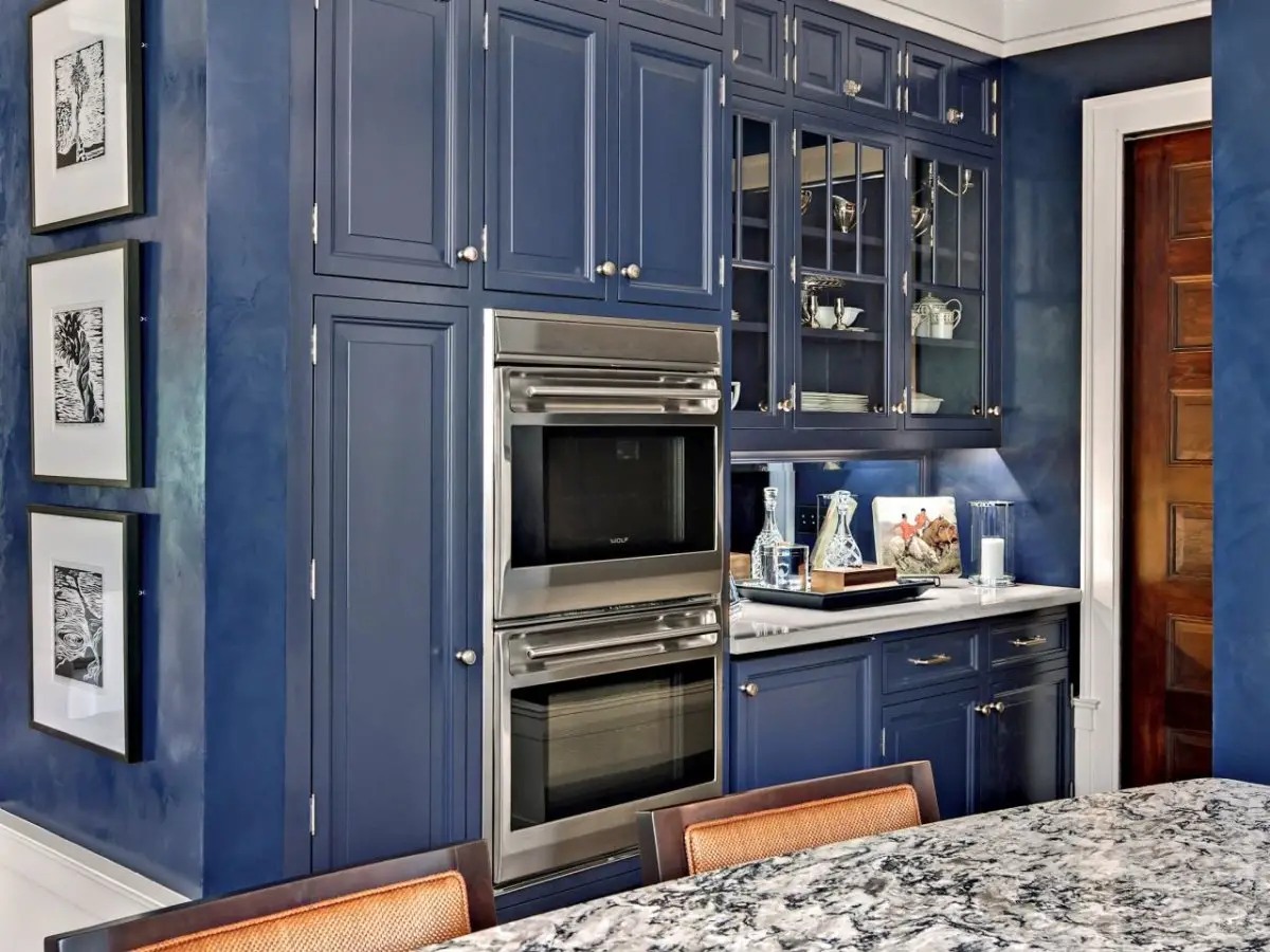 Modern blue kitchen with stainless steel appliances.