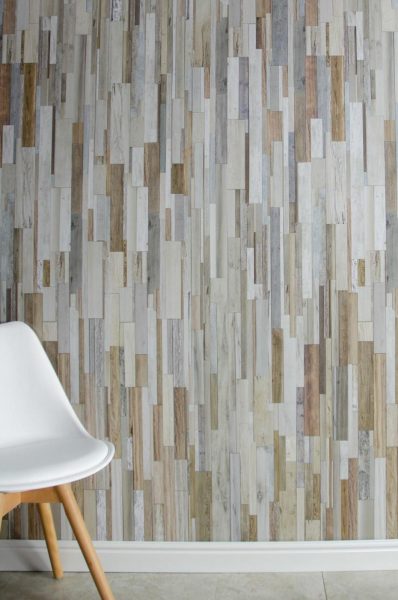 A white chair sits in front of wall panels.
