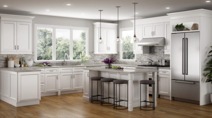 A kitchen renovation featuring white cabinets and stainless steel appliances.
