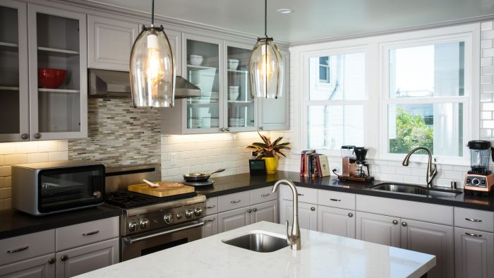 Kitchen remodeling with white cabinets and stainless steel appliances.