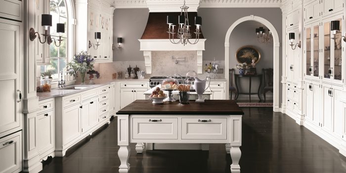 Kitchen remodeling with white cabinets and a black island.