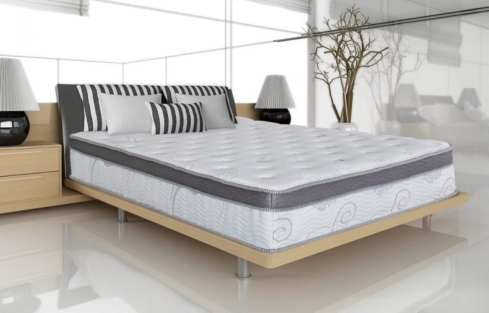 A comfortable bed with a high-quality mattress and soft pillows in a cozy bedroom.