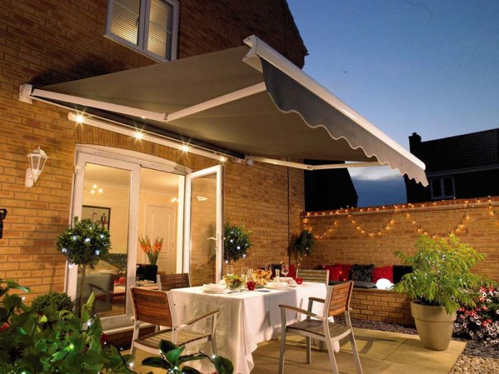 An outdoor dining area with a patio awning featuring outdoor features.