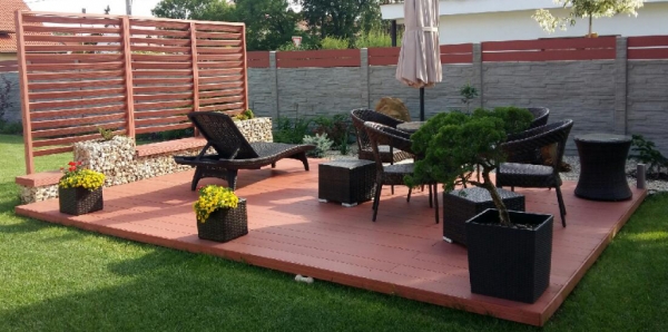 A backyard with composite decking and chairs.