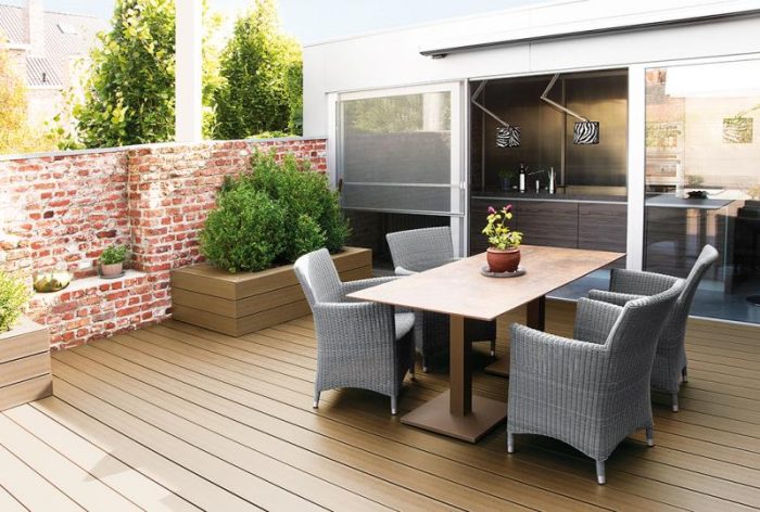 A composite decking with a table and chairs.