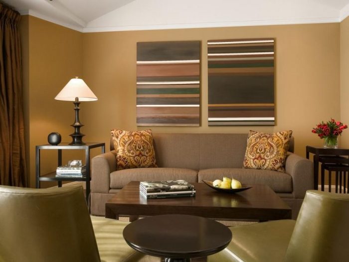 A living room with cozier beige walls and brown furniture.