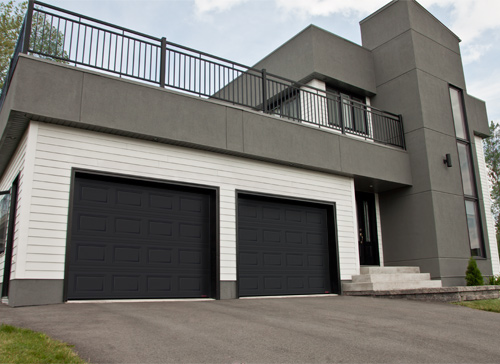 A property with a black garage door.