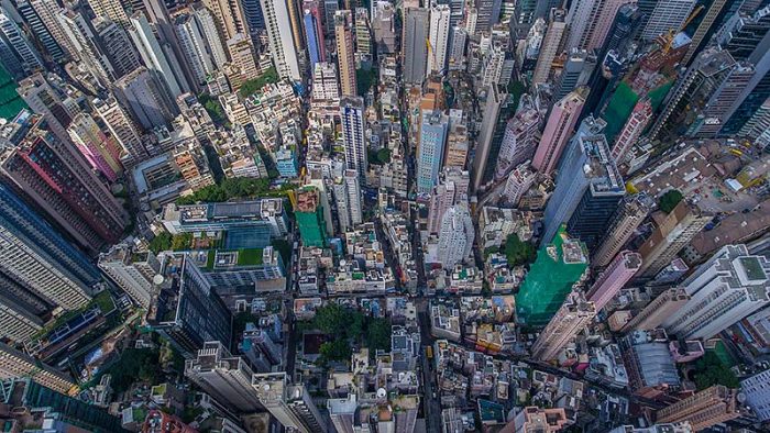 An aerial view of a city with tall buildings, showcasing the bustling work environment in Hong Kong.