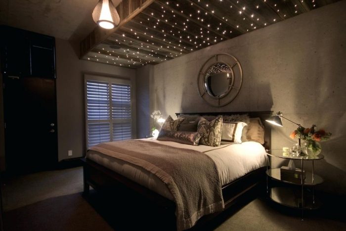 A cozy bedroom with a bed and charming ceiling lights.