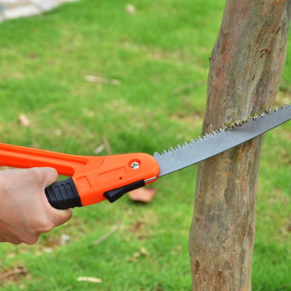 A person using tools for gardening to cut a tree with an orange saw.