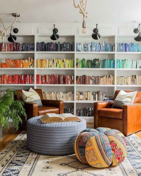 A living room with colorful bookshelves and chairs, providing seven storage ideas for small homes.