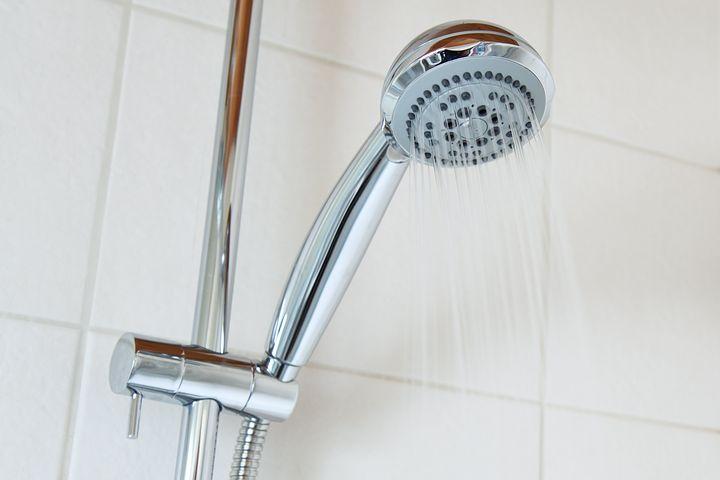 A shower head with an attached water heater.
