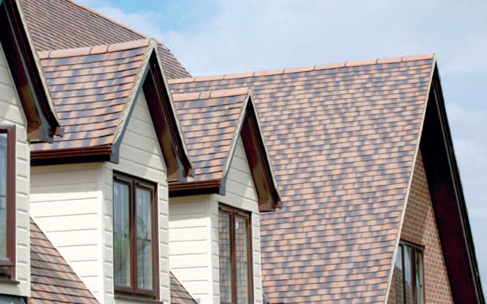 A house with a brown shingled roof featuring best energy roofing.