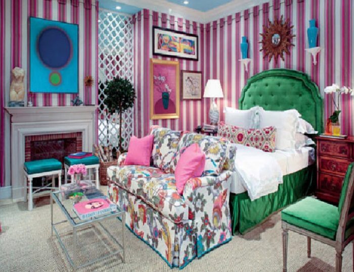 A pink and green living bedroom with striped walls.