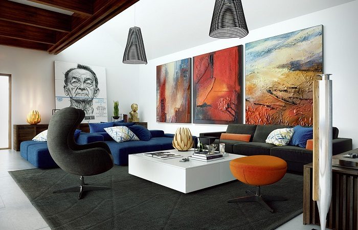 A spacious living room with a large painting on the wall.
