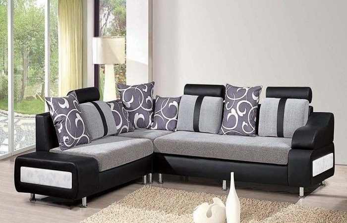 A black and grey sectional sofa set in a living room.