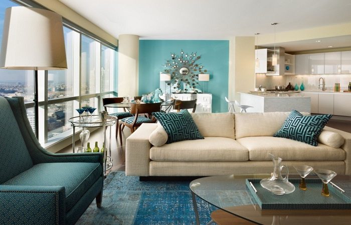 A living room with blue walls and a coffee table featuring furniture.