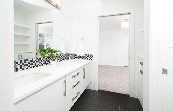 A monochrome bathroom with black and white tile.