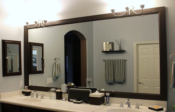 A bathroom with a mirror.