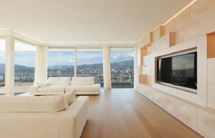 A colorful living room with a TV and a view of the city.
