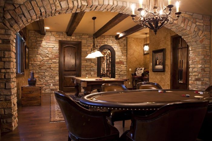 A game room with high ceilings, a poker table and chairs.