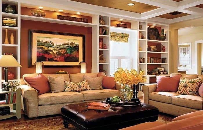 A home interior with tan furniture and bookshelves.