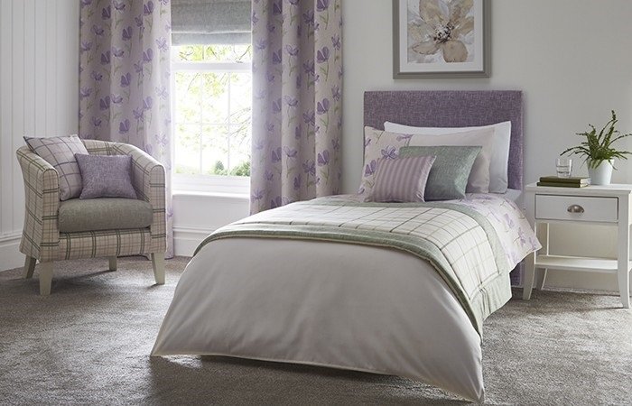 A purple bedroom with a bed.