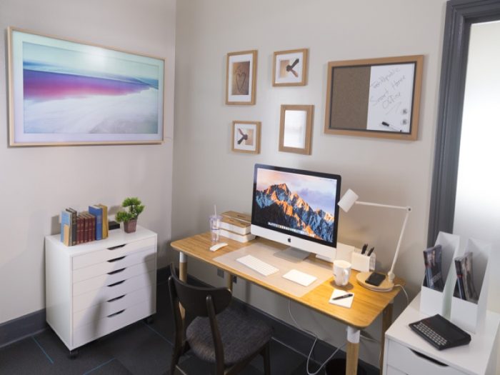 An image of a home office with a computer and a desk.