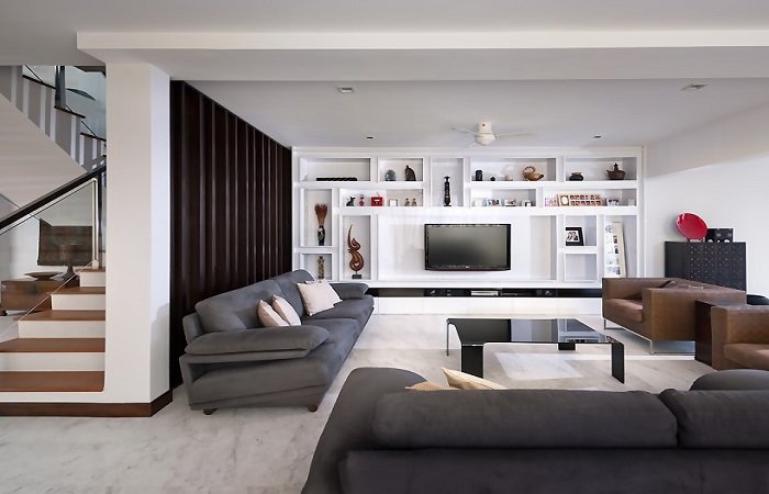A landed living room with couches and a tv.