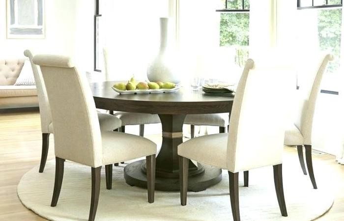 A round dining table and chairs in a kitchen.
