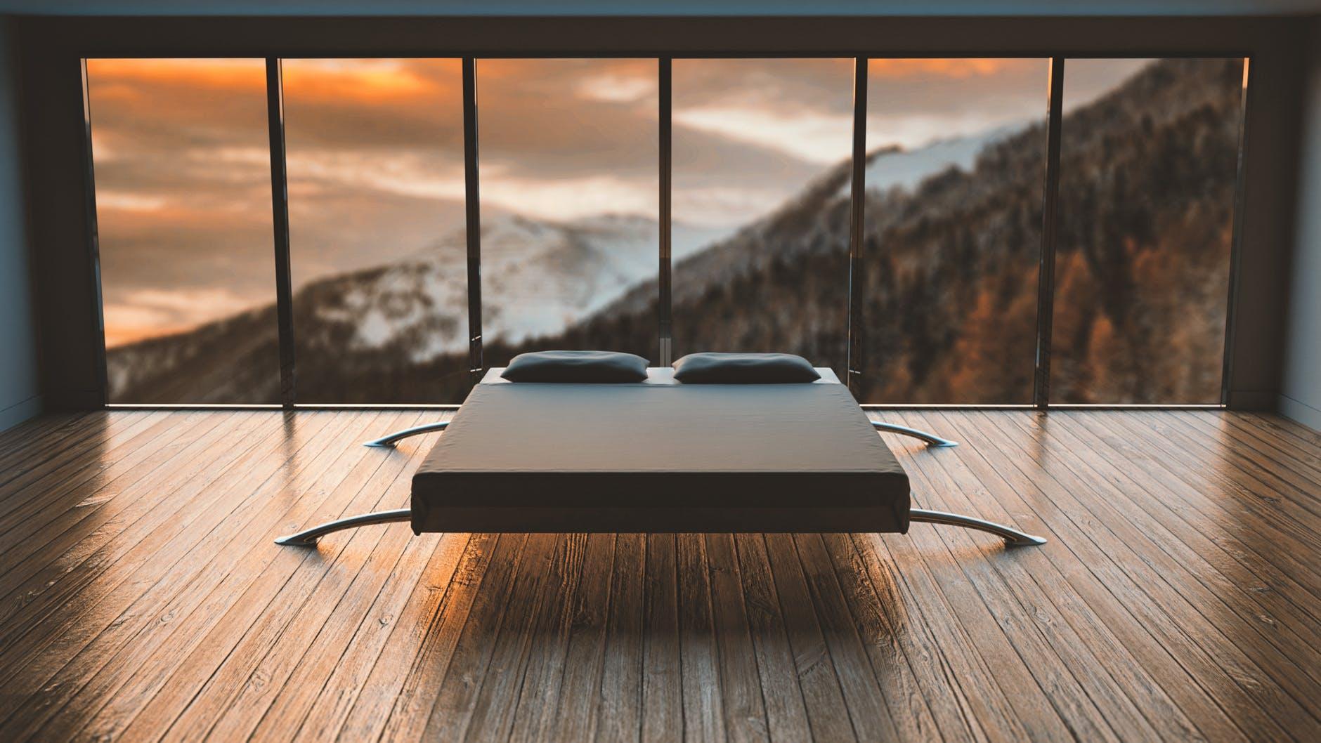 A room with a view of mountains and engineered wood flooring.