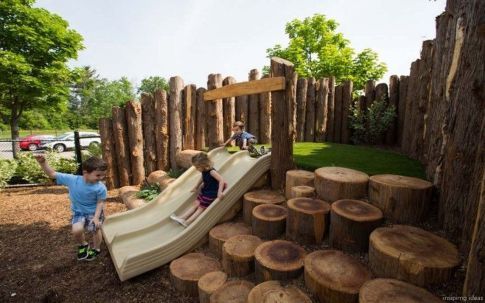 A kids' playground with a log slide.