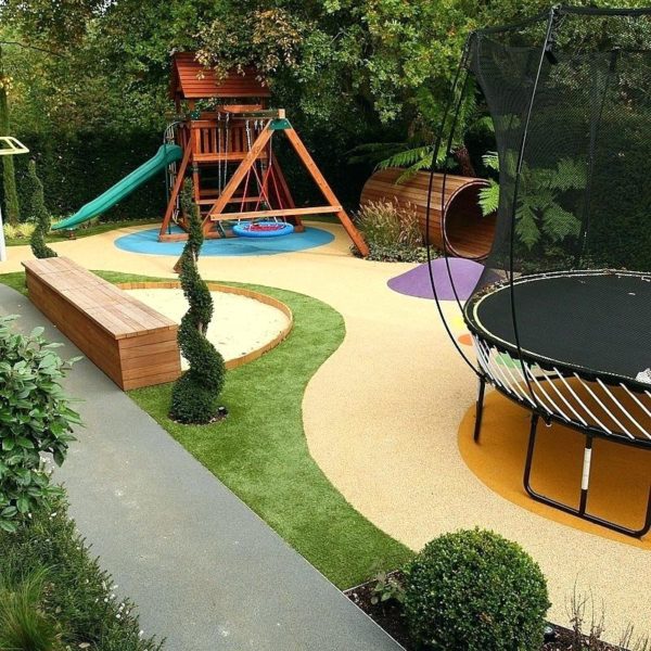 A playground for kids with trampoline and swings.