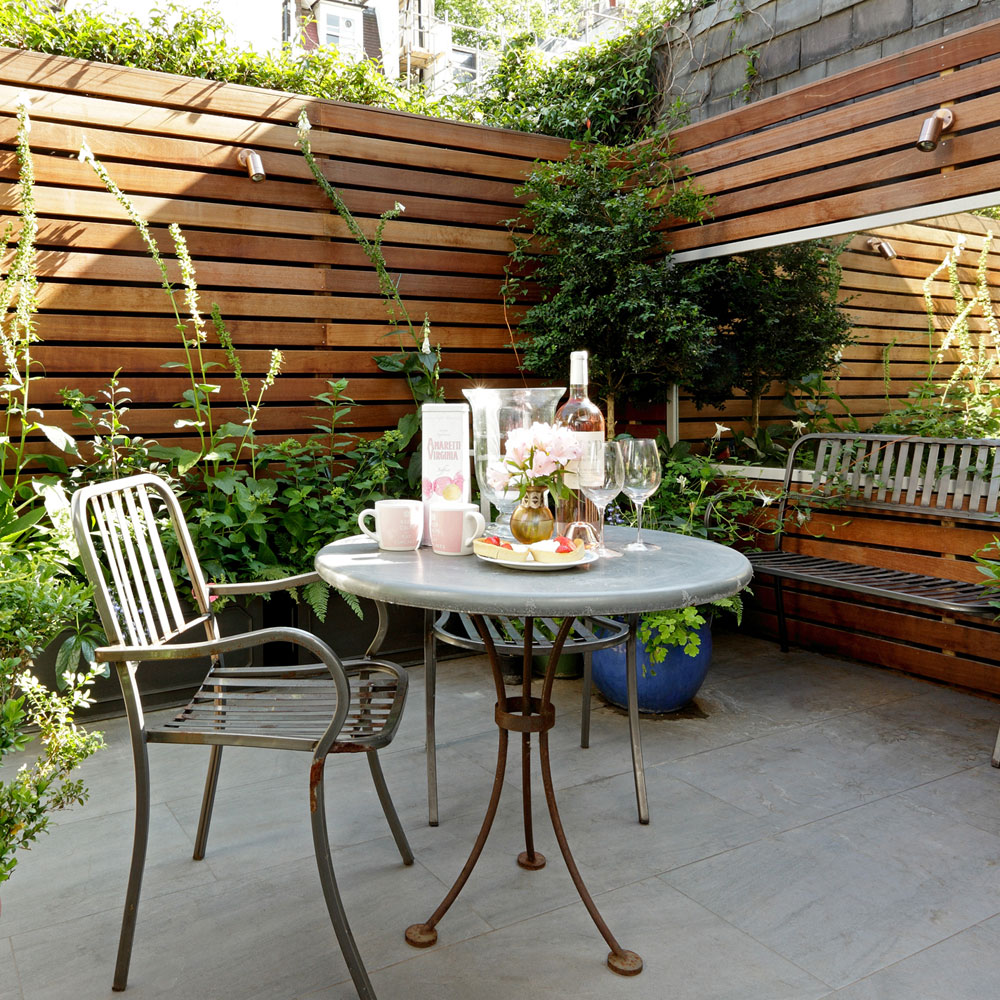 A small patio with a table and chairs.