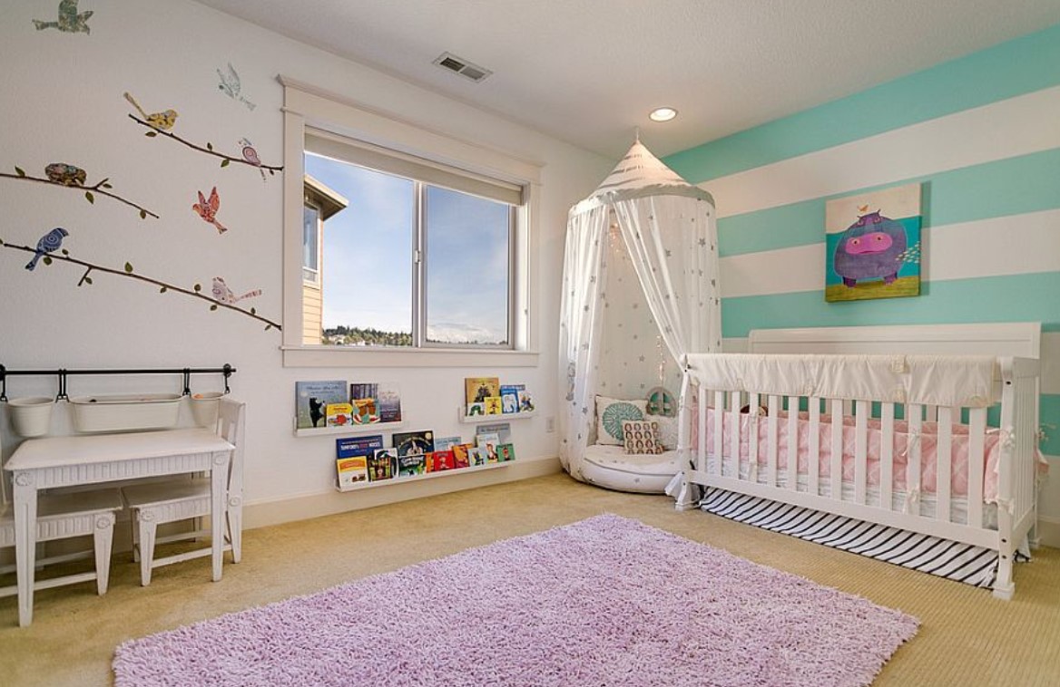 Nursery design featuring striped walls and a crib.