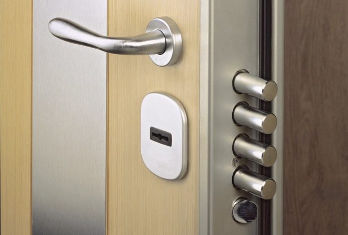 A close up of a door with a lock and handle emphasizing home security.
