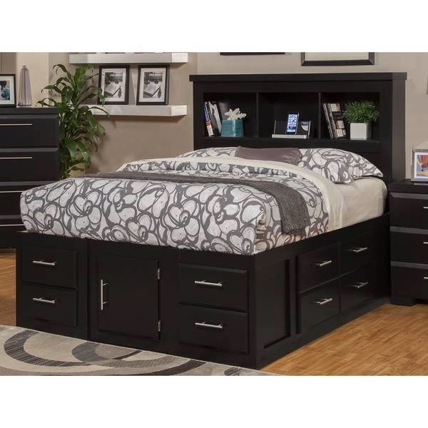 A black bed with storage drawers.
