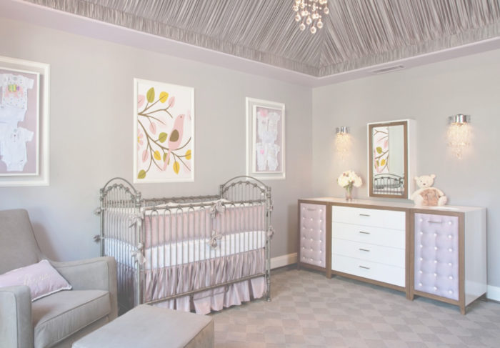 Nursery design with a crib and chandelier.