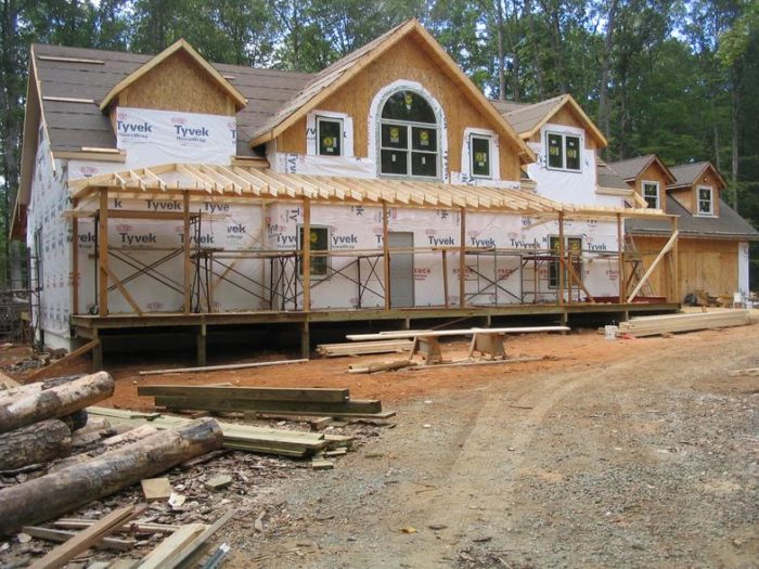 A house is being built in the woods with Knauf insulation.