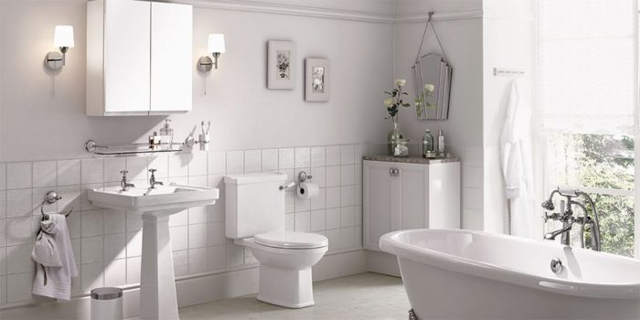A white bathroom with a bathtub, sink, and toilet, perfect for a bathroom upgrade.