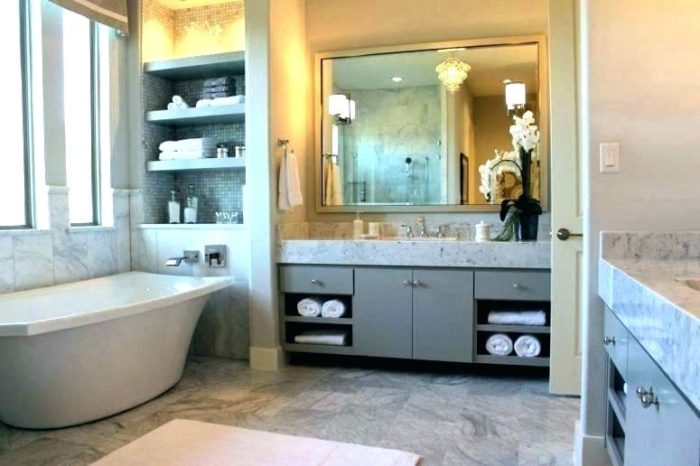 A bathroom upgrade with marble counter tops and a tub.