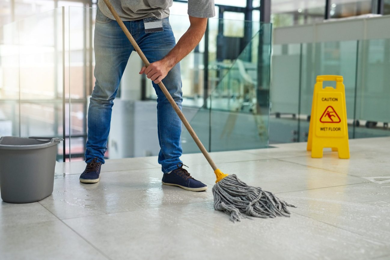 A janitor cleaning a floor.