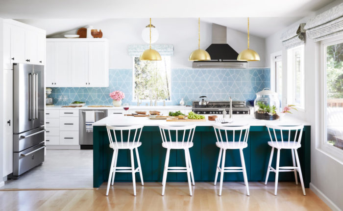 A blue and white kitchen designed with white stools.