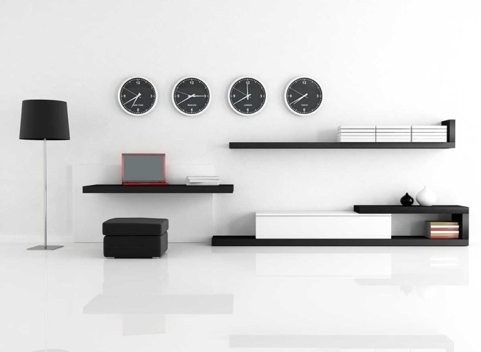 A minimalist living room with a clock on the wall.